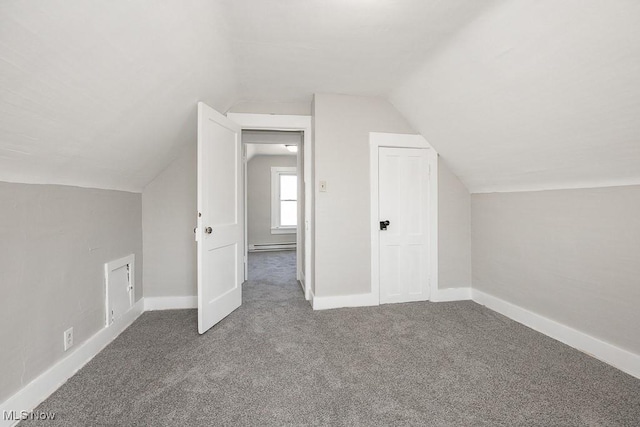 additional living space with carpet flooring, lofted ceiling, a baseboard heating unit, and baseboards