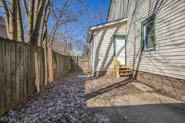 exterior space with entry steps and a fenced backyard