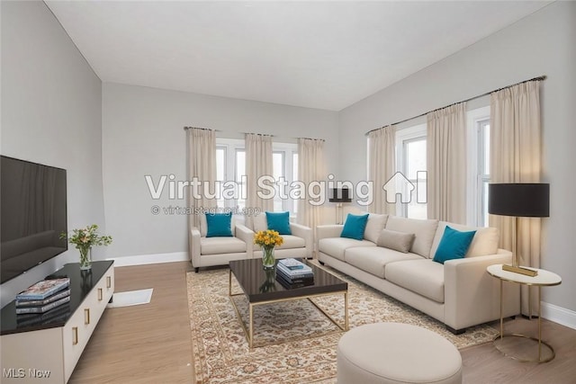 living area featuring light wood-type flooring and baseboards