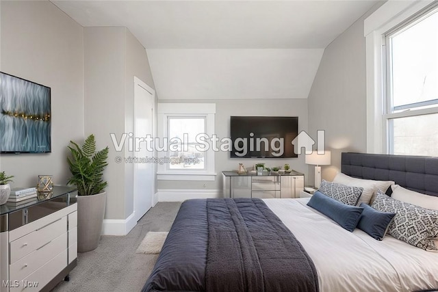 bedroom with carpet flooring, baseboards, and vaulted ceiling