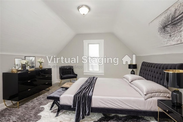 bedroom with carpet floors, baseboards, and vaulted ceiling