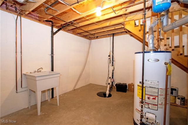 unfinished basement featuring gas water heater and concrete block wall