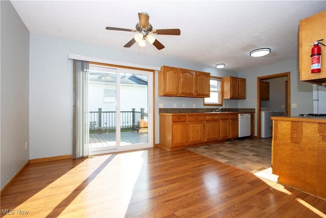 kitchen with light wood-style floors, dishwasher, and a healthy amount of sunlight