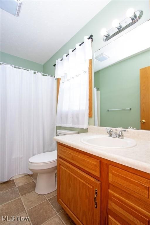 bathroom with vanity, tile patterned floors, toilet, and visible vents