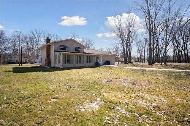 rear view of property with a lawn and a chimney