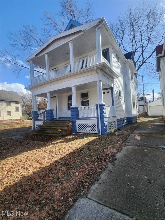 view of front of home with a porch and a balcony