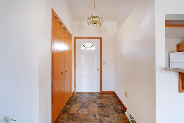 entryway featuring stone finish flooring and baseboards