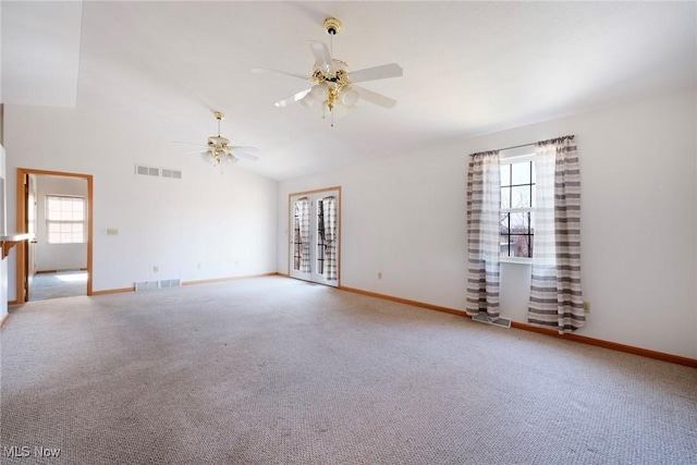 unfurnished room with visible vents, plenty of natural light, and light colored carpet