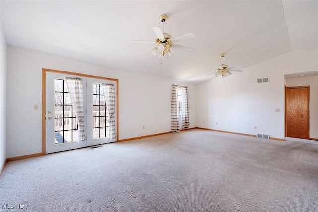 empty room with visible vents, light carpet, and a ceiling fan