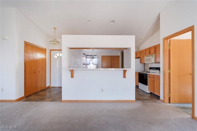 kitchen with dark carpet, white appliances, light countertops, and vaulted ceiling