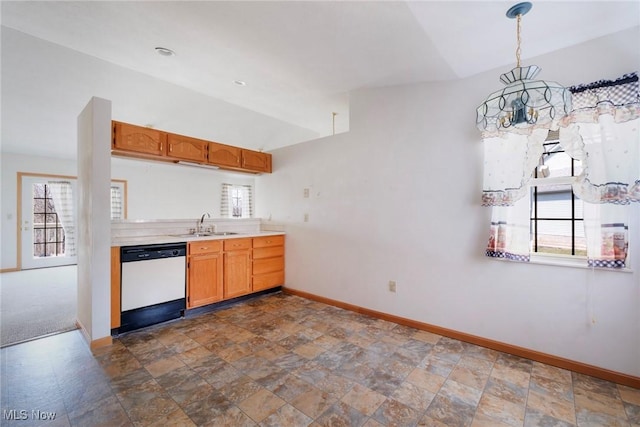 kitchen featuring baseboards, light countertops, vaulted ceiling, white dishwasher, and a sink