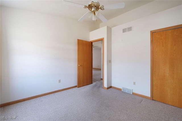 unfurnished room featuring baseboards, visible vents, a ceiling fan, and carpet