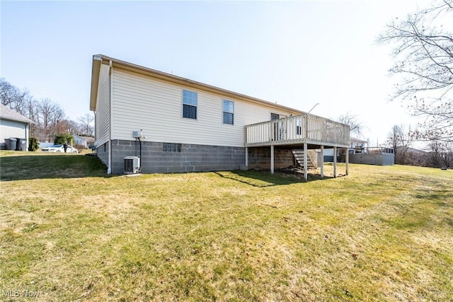 back of property with a yard, a wooden deck, and stairs