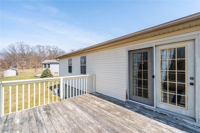 deck with a yard and an outbuilding