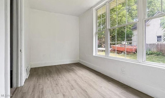 empty room with wood finished floors and baseboards