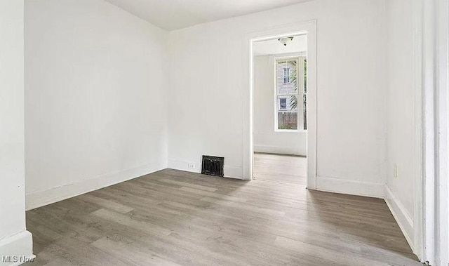empty room featuring visible vents and wood finished floors
