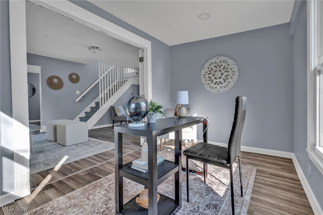 office area featuring baseboards and wood finished floors