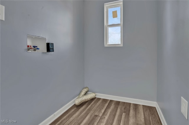 washroom featuring laundry area, wood finished floors, baseboards, and washer hookup