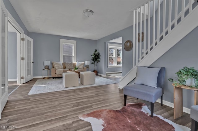 interior space featuring stairway, baseboards, and wood finished floors