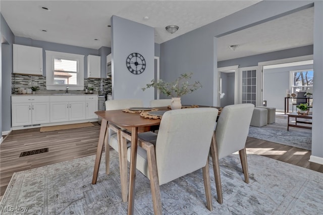 dining area featuring visible vents and light wood finished floors