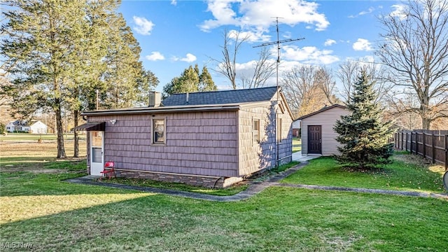 exterior space with an outbuilding and fence