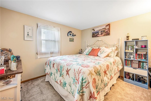 bedroom with carpet and baseboards