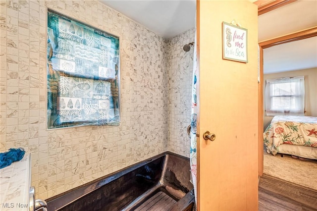 full bath with wood finished floors, ensuite bathroom, and tiled shower