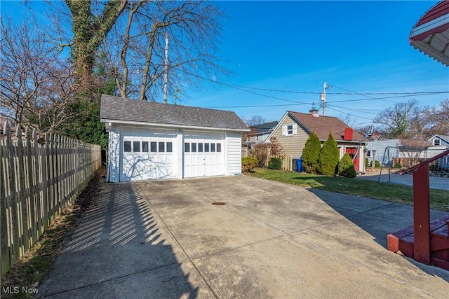 detached garage featuring fence