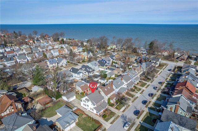 drone / aerial view featuring a residential view and a water view