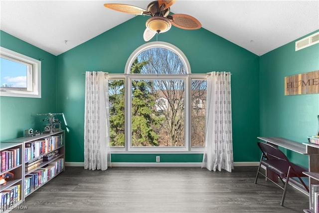 office space featuring a ceiling fan, wood finished floors, visible vents, baseboards, and lofted ceiling