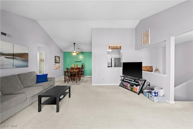 carpeted living room with visible vents, high vaulted ceiling, baseboards, and a ceiling fan