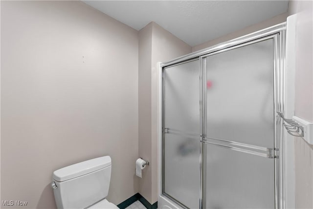 full bathroom with toilet and a shower stall