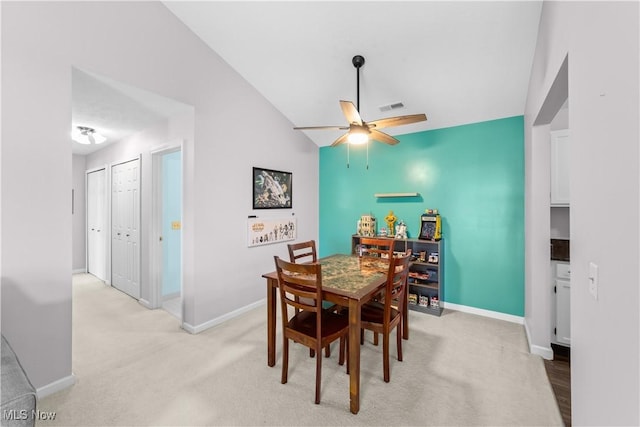 dining space featuring visible vents, light carpet, baseboards, and ceiling fan