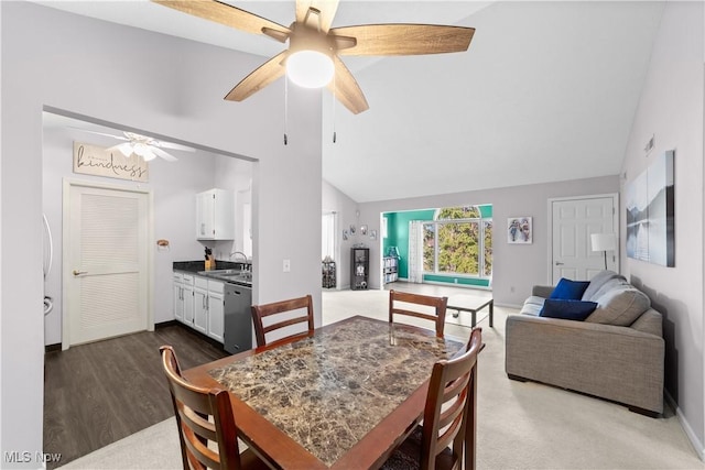 dining space with baseboards, dark wood-type flooring, high vaulted ceiling, and ceiling fan