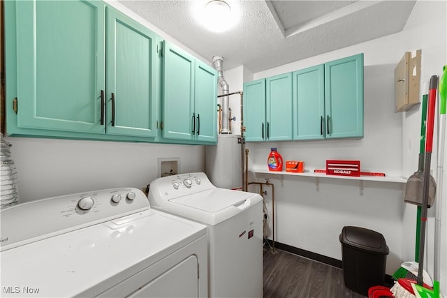 clothes washing area with dark wood-style floors, cabinet space, a textured ceiling, washer and dryer, and gas water heater