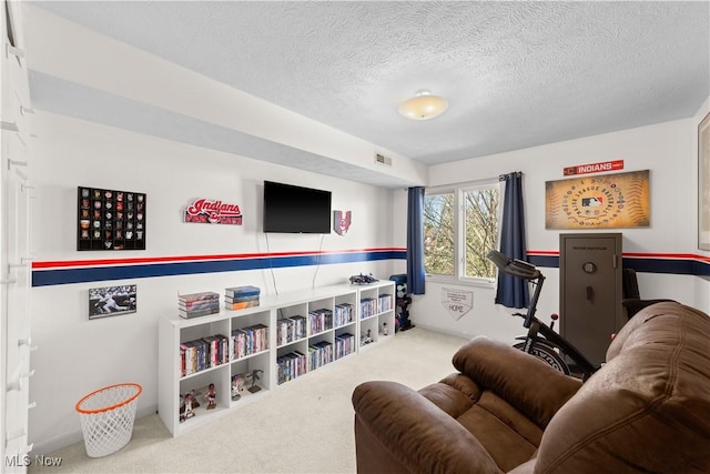 rec room featuring visible vents, a textured ceiling, and carpet flooring