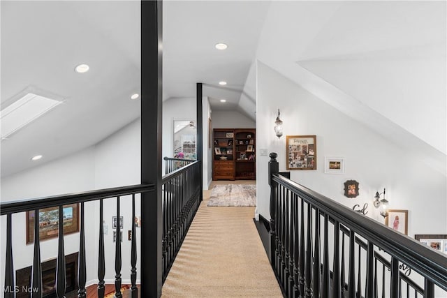 hall featuring an upstairs landing, carpet flooring, recessed lighting, and vaulted ceiling