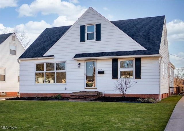 bungalow-style house with a shingled roof and a front lawn