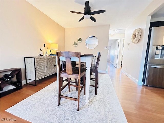 dining area featuring a ceiling fan, wood finished floors, and baseboards