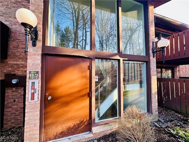 entrance to property featuring brick siding