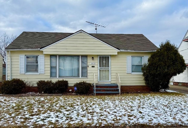 bungalow featuring a shingled roof