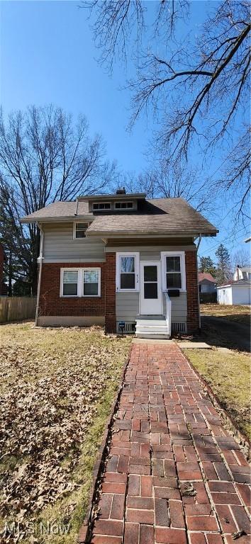 back of house with entry steps and brick siding