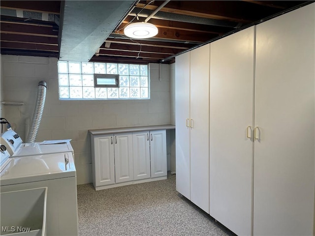 washroom with cabinet space and washing machine and dryer