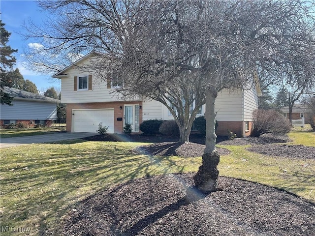 view of front of house featuring concrete driveway, a garage, and a front lawn