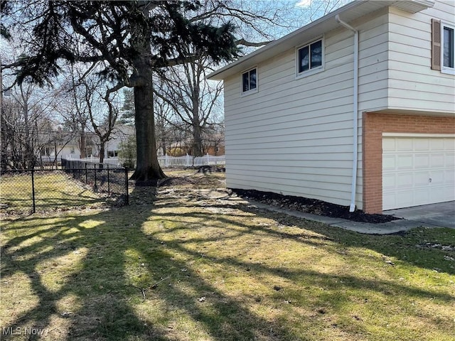 view of home's exterior with a garage, brick siding, a lawn, and fence