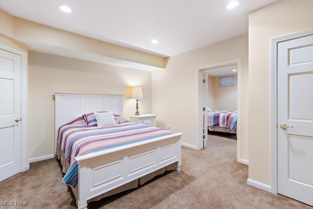 bedroom with recessed lighting, baseboards, and light carpet