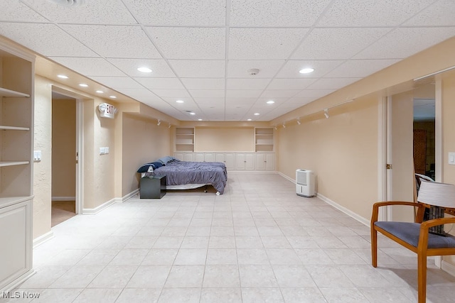 bedroom with light tile patterned floors, recessed lighting, baseboards, and a paneled ceiling