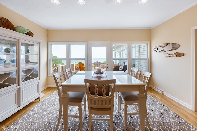 dining space featuring recessed lighting, light wood-style flooring, baseboards, and ornamental molding