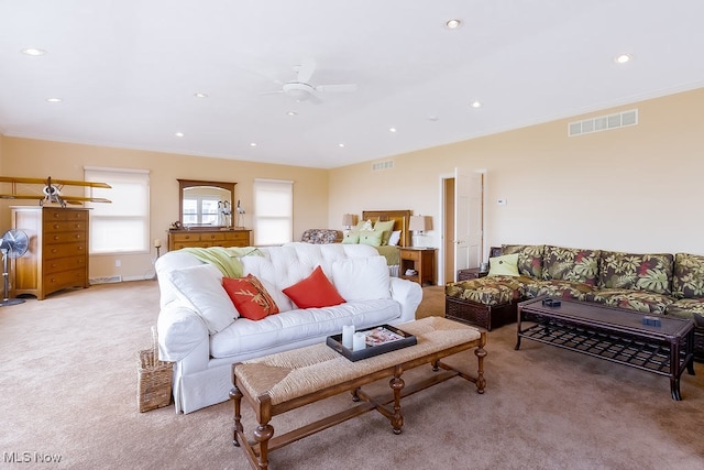 living area featuring recessed lighting, visible vents, light carpet, and crown molding