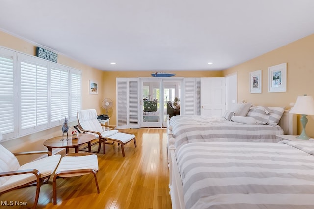 bedroom featuring light wood finished floors, recessed lighting, and access to outside